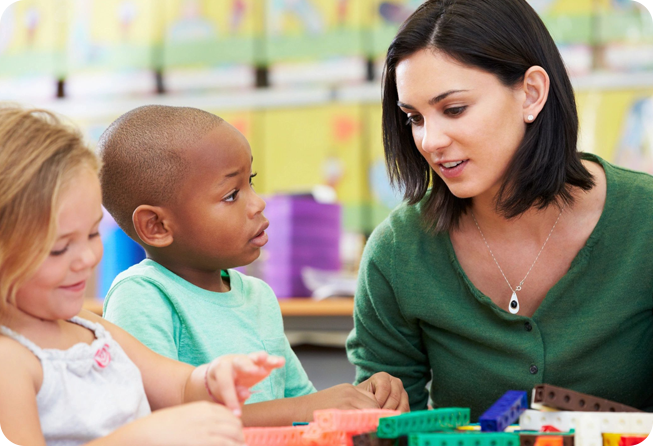 A woman and child playing with blocks in a room.