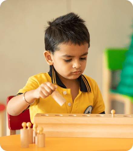 A young boy is playing with wooden toys.