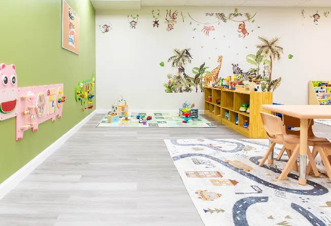 An inside of a play school with tables, chairs and more