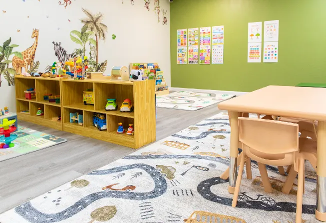 An inside of a play school with tables, chairs and more