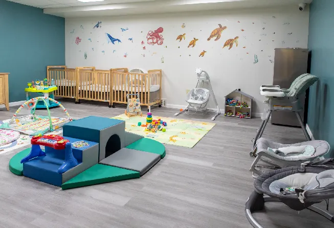 An inside of a play school with tables, chairs and more